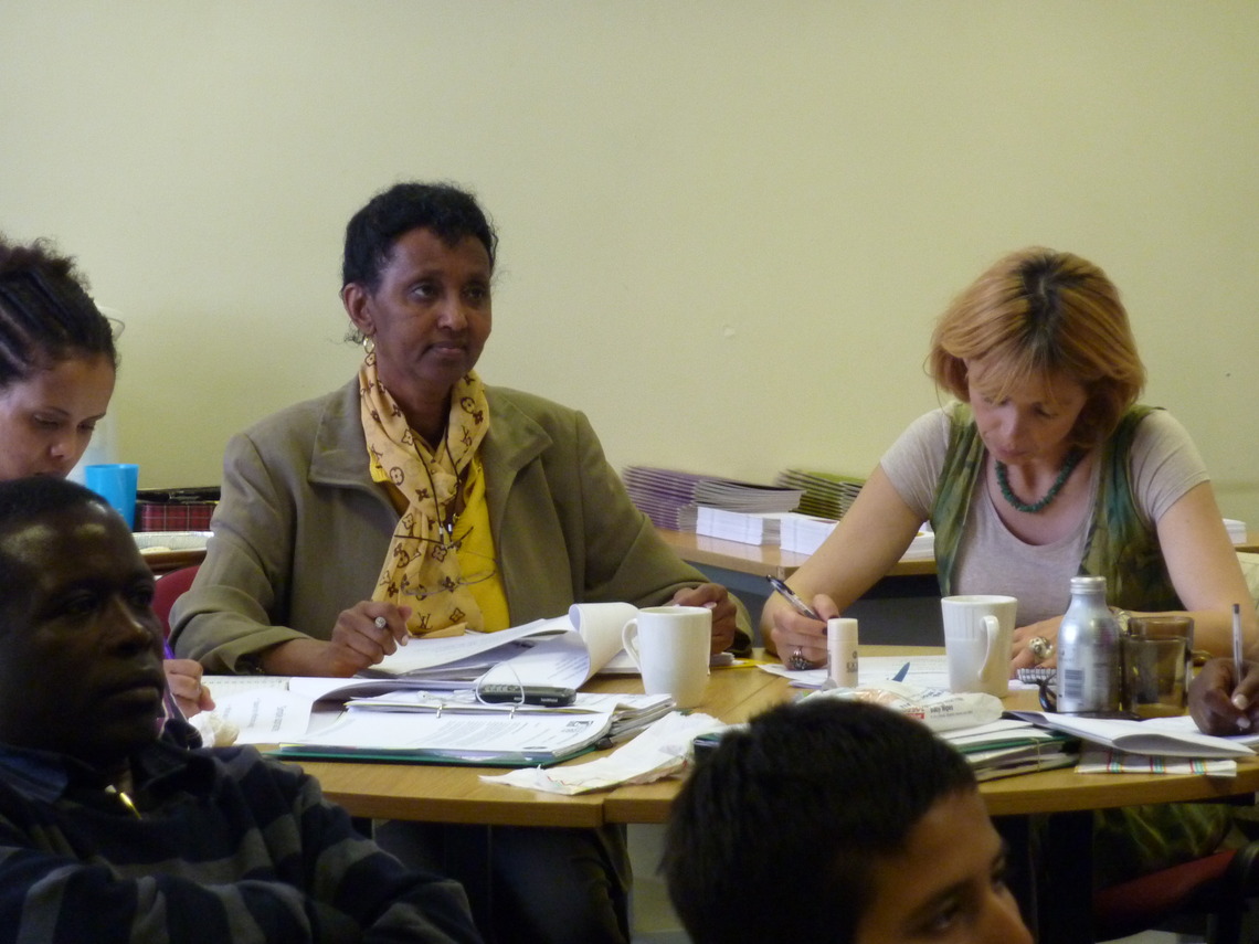 Photo of three people sitting at tables